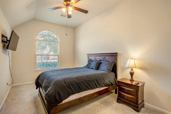 a bedroom with a bed and a flat screen tv