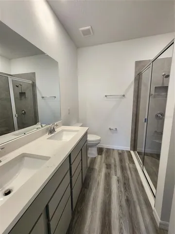 a spacious bathroom with a double vanity sink and mirror