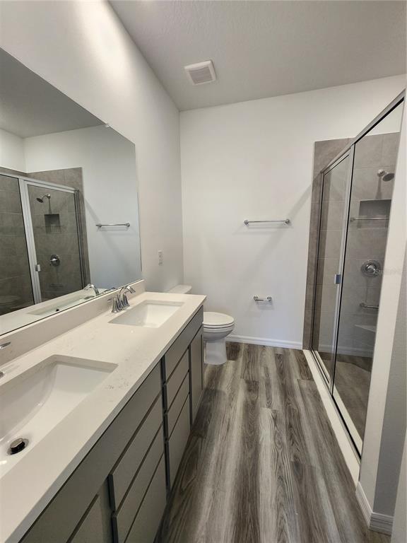 32760 Rustic Rise Road San Antonio, FL 33576 - Photo 12 of 27 a spacious bathroom with a double vanity sink and mirror
