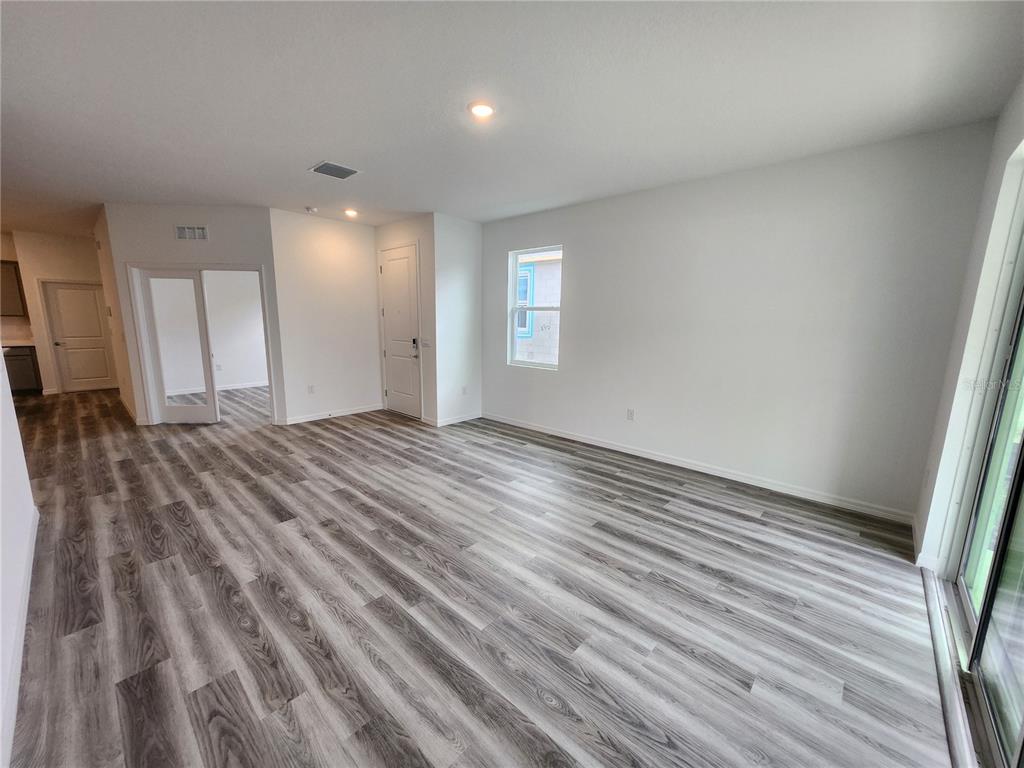 32760 Rustic Rise Road San Antonio, FL 33576 - Photo 14 of 27 a view of a room with wooden floor and window