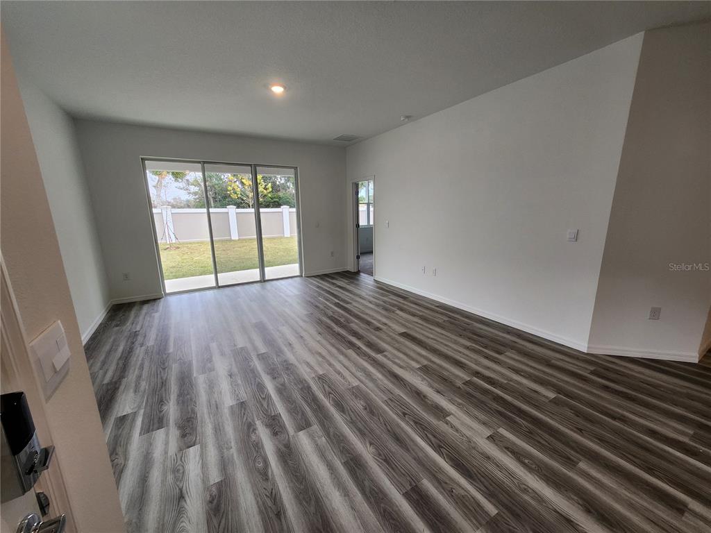 32760 Rustic Rise Road San Antonio, FL 33576 - Photo 15 of 27 a view of an empty room with wooden floor and a window