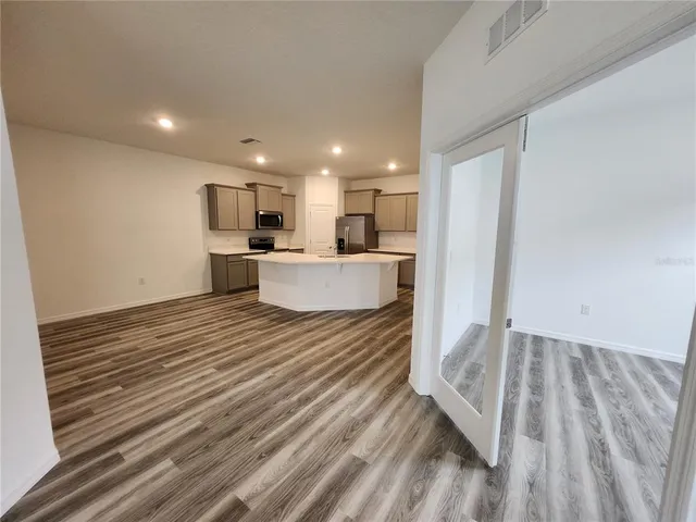a view of kitchen and wooden floor