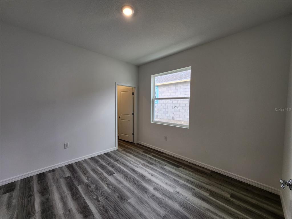 32760 Rustic Rise Road San Antonio, FL 33576 - Photo 17 of 27 a view of an empty room and window