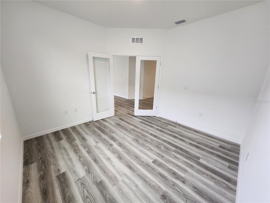 32760 Rustic Rise Road San Antonio, FL 33576 - Photo 18 of 27 a view of empty room with wooden floor