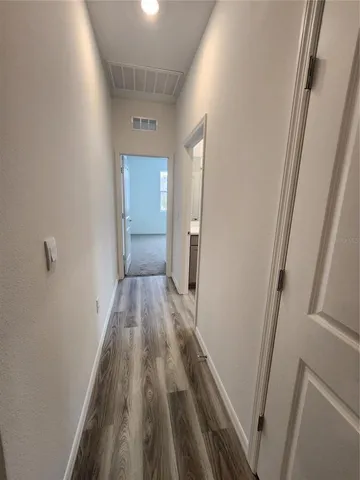 a view of hallway with wooden floor
