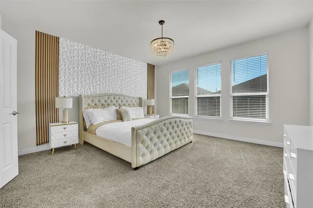 a spacious bedroom with a bed and a window