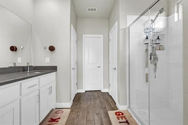 a bathroom with a sink a mirror and shower