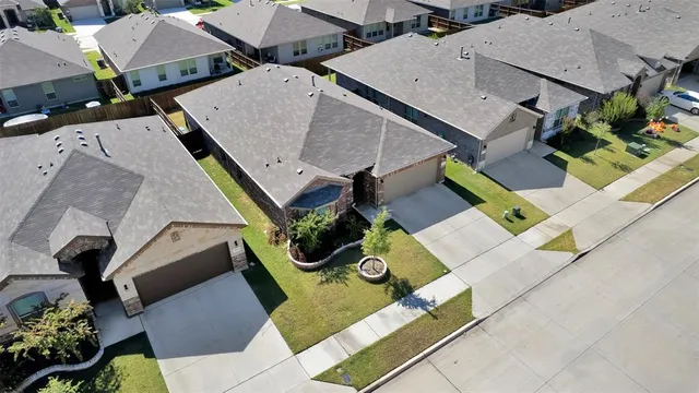 an aerial view of multiple houses with yard