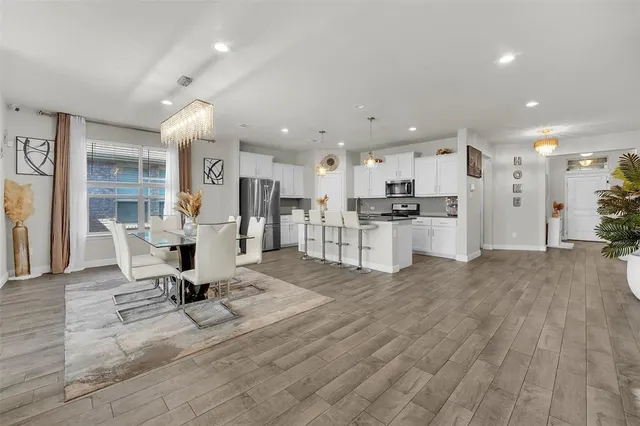 a living room with furniture and kitchen view
