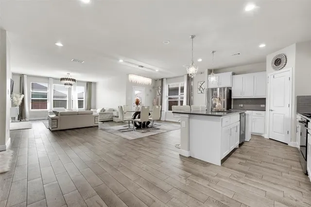 a living room with furniture and kitchen view