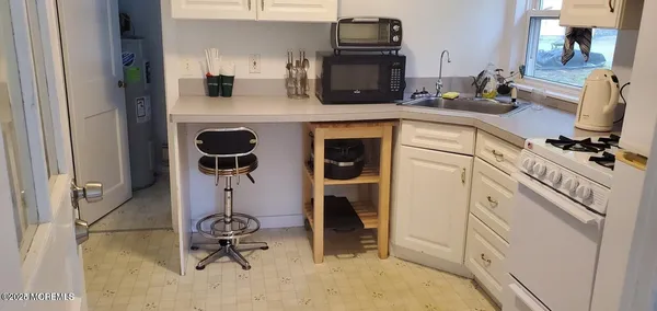 a kitchen with a sink appliances and cabinets