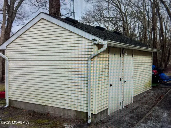 a small white house with a white roof and a yard