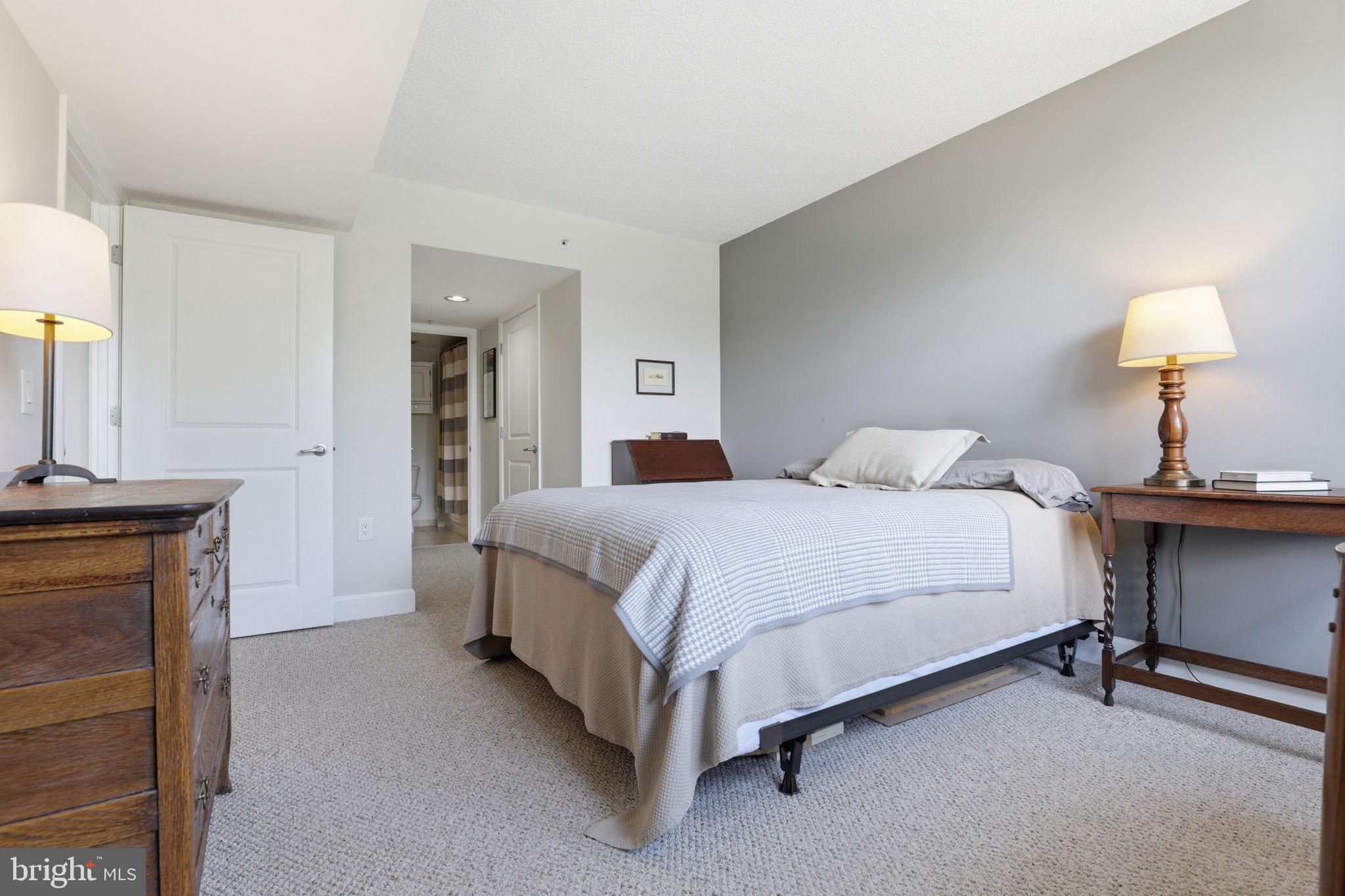 11800 Sunset Hills Road, Unit 218 Reston, VA 20190 - Photo 21 of 38 a bedroom with a bed and a table