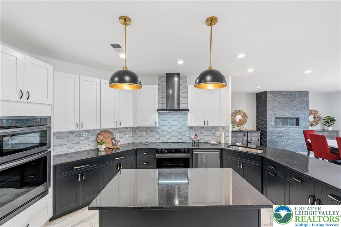 901 Meyer Road Nazareth, PA 18064 - Photo 23 of 80 a kitchen with stainless steel appliances granite countertop a sink a stove and a wooden floors