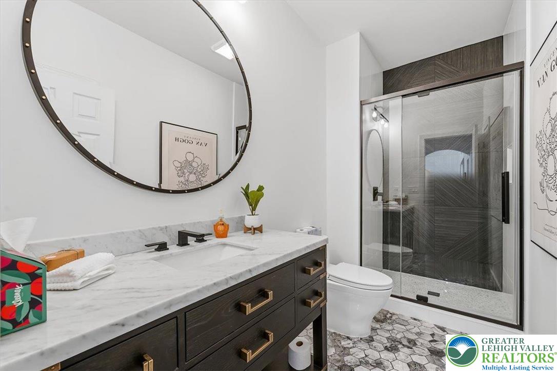 901 Meyer Road Nazareth, PA 18064 - Photo 32 of 80 a bathroom with a granite countertop sink a mirror a toilet and shower