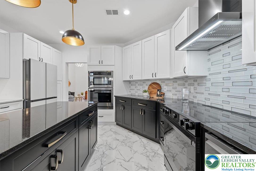 901 Meyer Road Nazareth, PA 18064 - Photo 35 of 80 a kitchen with stainless steel appliances granite countertop a sink a stove and a refrigerator