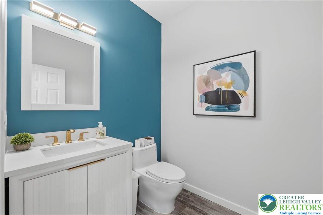 901 Meyer Road Nazareth, PA 18064 - Photo 37 of 80 a bathroom with a toilet sink vanity and mirror