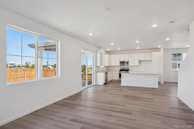 a view of kitchen with wooden floor and windows