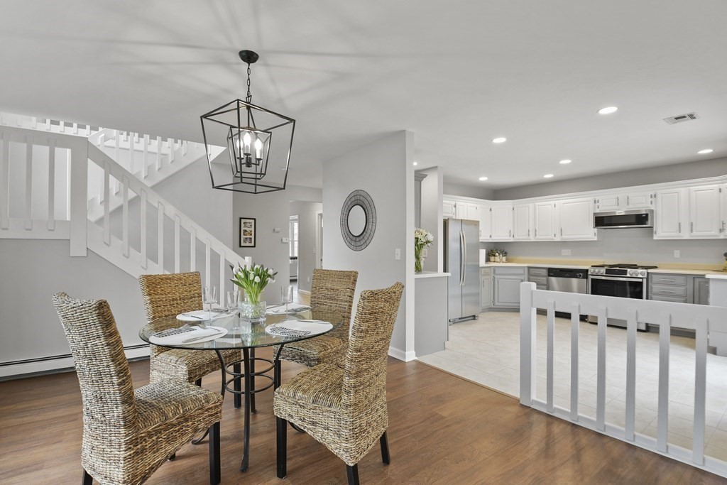 307 Ridgefield Circle, Unit D Clinton, MA 01510 - Photo 11 of 42 a view of a dining room with furniture a chandelier and wooden floor