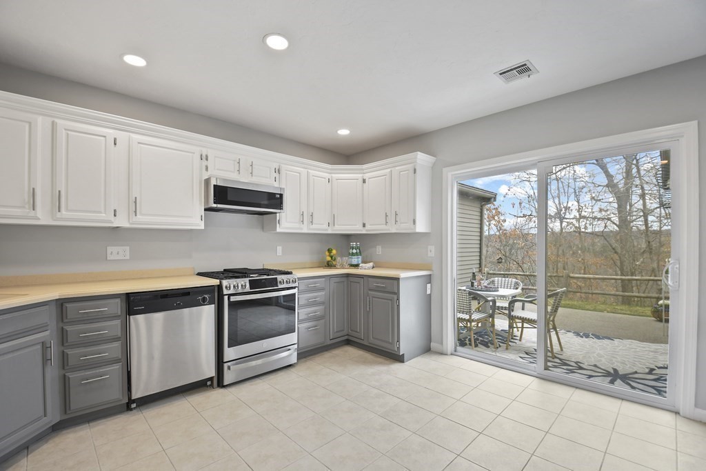 307 Ridgefield Circle, Unit D Clinton, MA 01510 - Photo 13 of 42 a kitchen with stainless steel appliances granite countertop a stove top oven a sink and a refrigerator