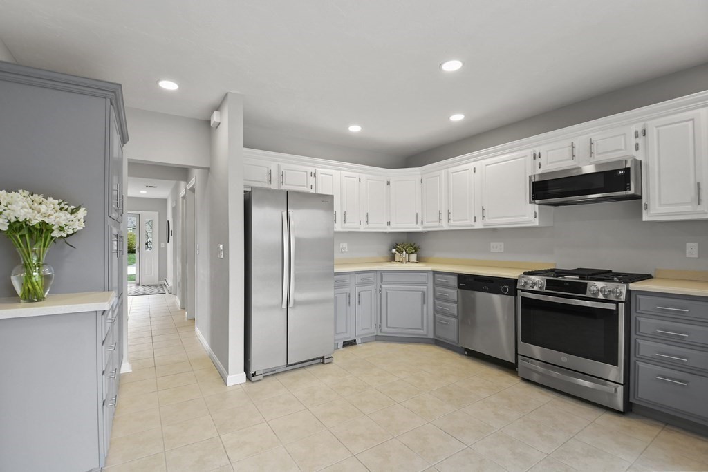 307 Ridgefield Circle, Unit D Clinton, MA 01510 - Photo 14 of 42 a kitchen with stainless steel appliances granite countertop a refrigerator a sink a stove and white cabinets