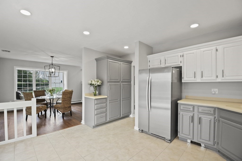 307 Ridgefield Circle, Unit D Clinton, MA 01510 - Photo 15 of 42 a kitchen with white cabinets and stainless steel appliances