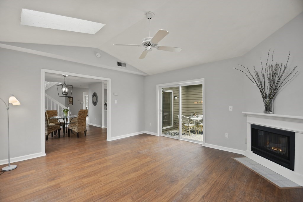 307 Ridgefield Circle, Unit D Clinton, MA 01510 - Photo 17 of 42 wooden floor fireplace and windows in an empty room