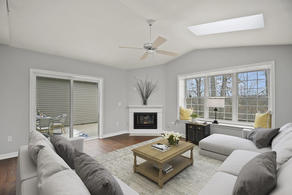 307 Ridgefield Circle, Unit D Clinton, MA 01510 - Photo 20 of 42 a living room with furniture a fireplace and a large window