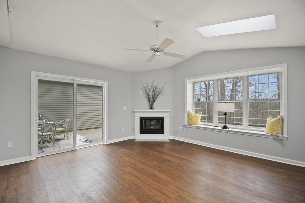 307 Ridgefield Circle, Unit D Clinton, MA 01510 - Photo 21 of 42 a view of an empty room with wooden floor and a window