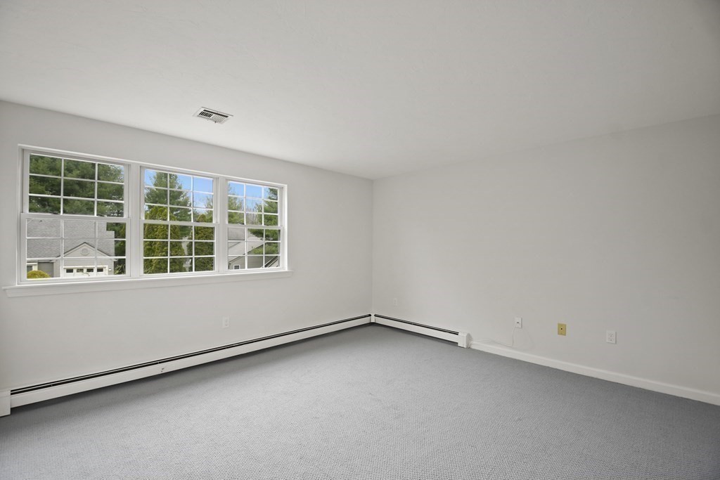 307 Ridgefield Circle, Unit D Clinton, MA 01510 - Photo 26 of 42 an empty room with a window