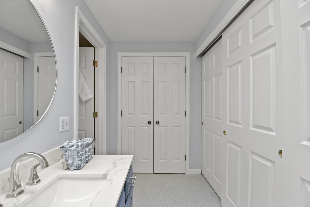 307 Ridgefield Circle, Unit D Clinton, MA 01510 - Photo 33 of 42 a bathroom with a sink and a mirror