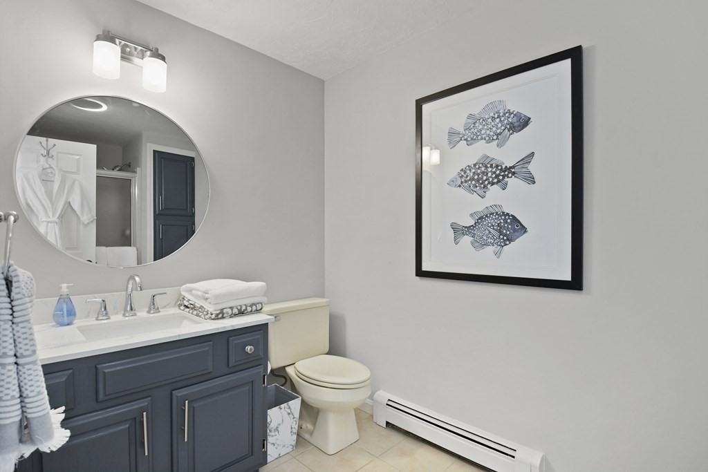307 Ridgefield Circle, Unit D Clinton, MA 01510 - Photo 34 of 42 a bathroom with a toilet a sink and mirror