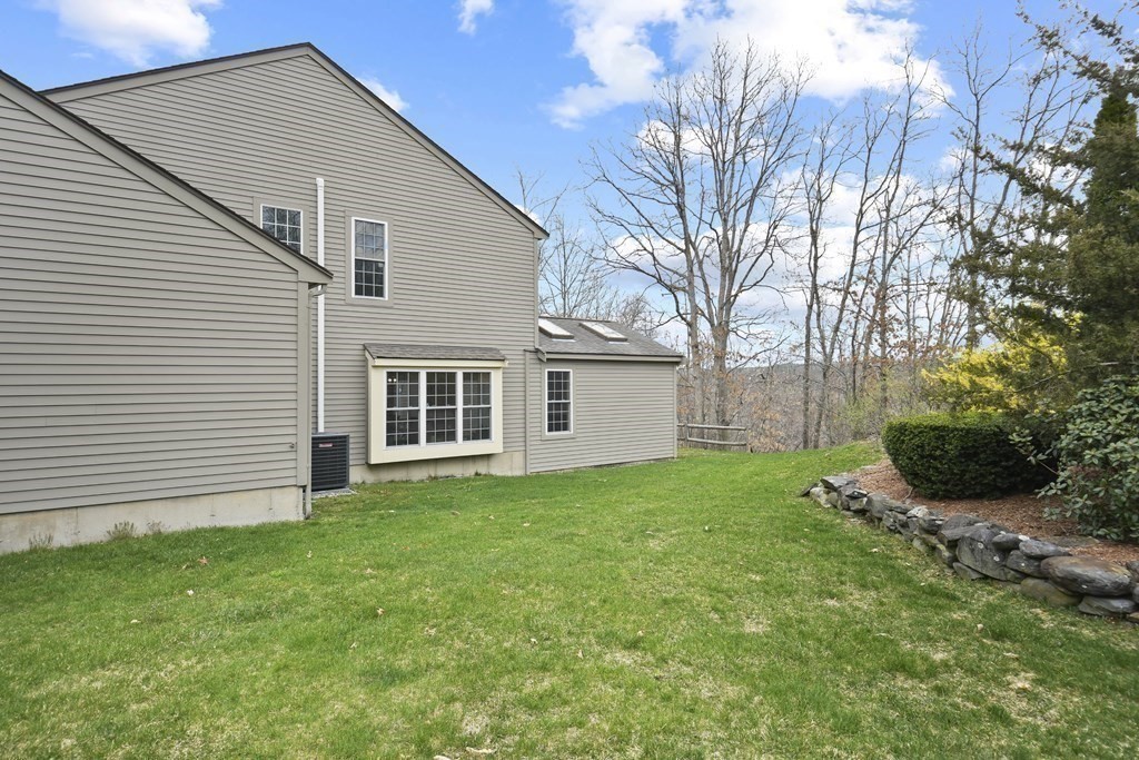 307 Ridgefield Circle, Unit D Clinton, MA 01510 - Photo 35 of 42 a view of a backyard with plants and large tree