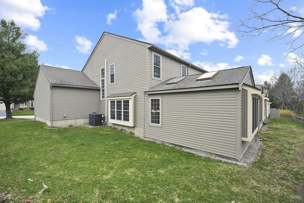 307 Ridgefield Circle, Unit D Clinton, MA 01510 - Photo 36 of 42 a view of a house with a backyard
