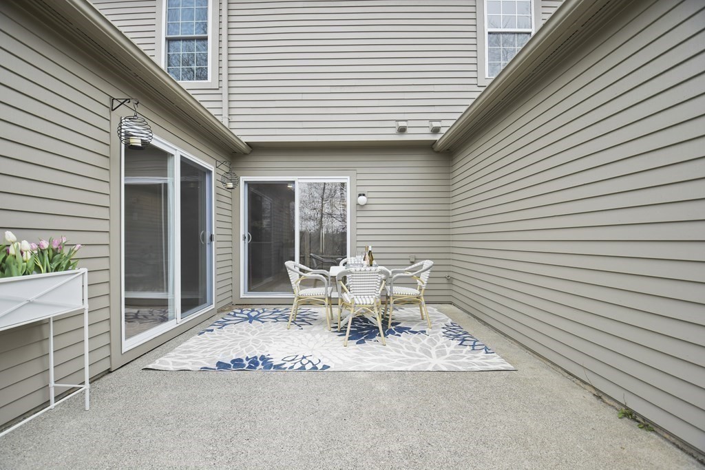 307 Ridgefield Circle, Unit D Clinton, MA 01510 - Photo 38 of 42 a white bench sitting in front of a house
