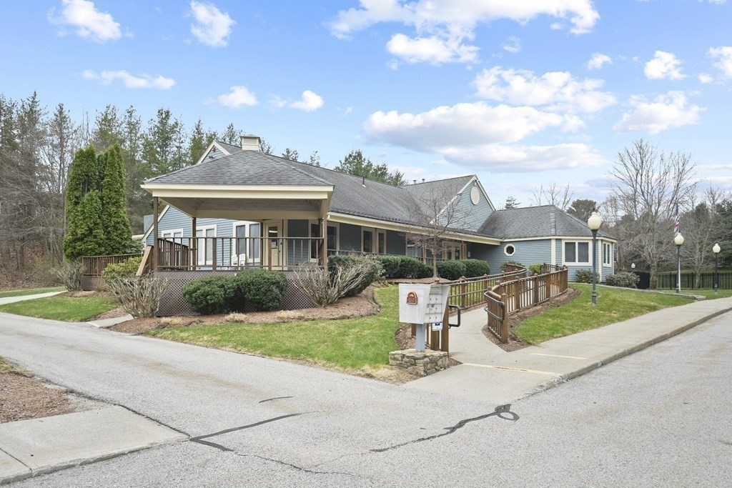 307 Ridgefield Circle, Unit D Clinton, MA 01510 - Photo 40 of 42 a front view of a house with a yard and potted plants