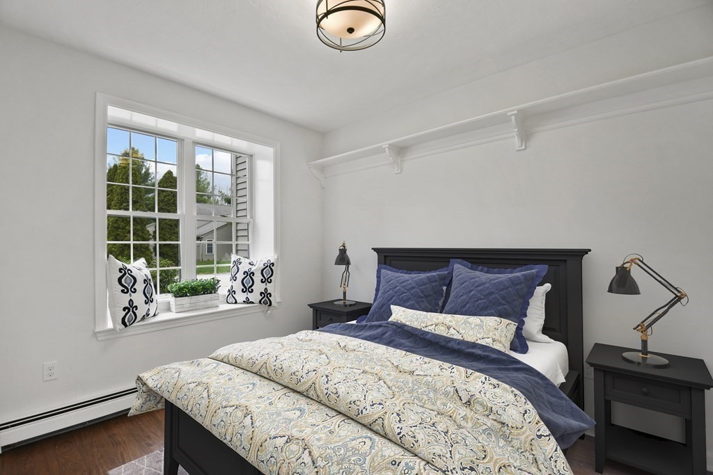 307 Ridgefield Circle, Unit D Clinton, MA 01510 - Photo 4 of 42 a bedroom with a bed and a window