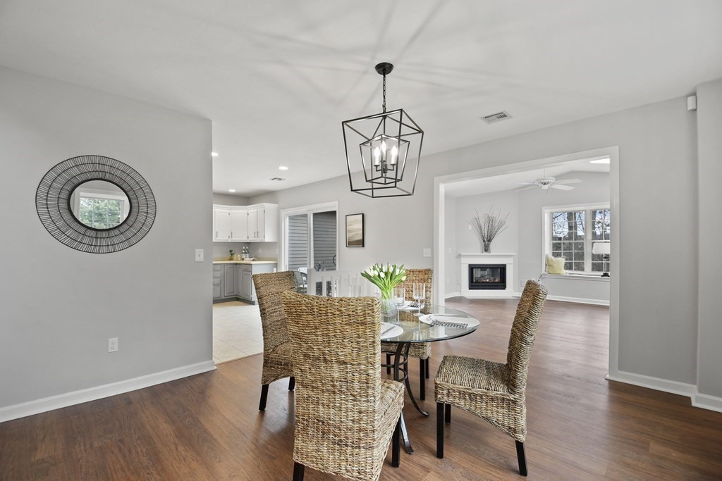 307 Ridgefield Circle, Unit D Clinton, MA 01510 - Photo 9 of 42 a view of a dining room with furniture wooden floor and chandelier