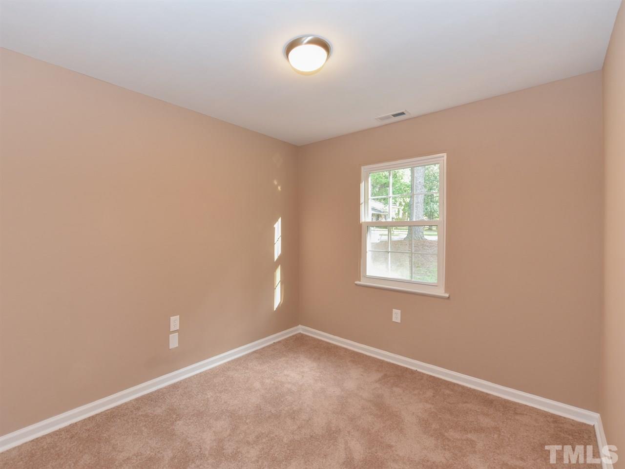 1221 Seabrook Road Raleigh, NC 27610 - Photo 13 of 16 an empty room with a window