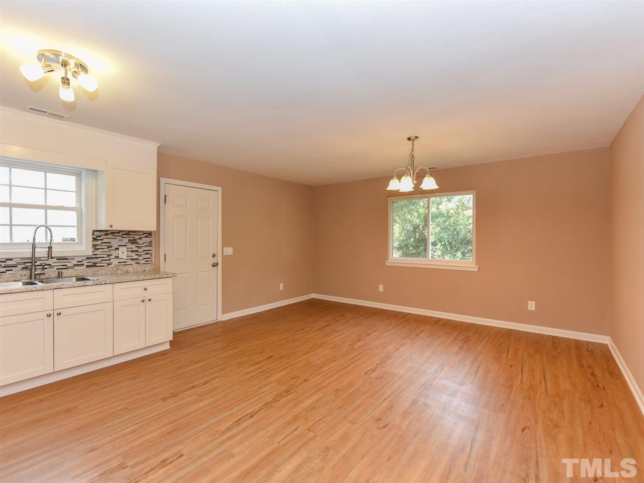 1221 Seabrook Road Raleigh, NC 27610 - Photo 4 of 16 a view of an empty room with window and wooden floor