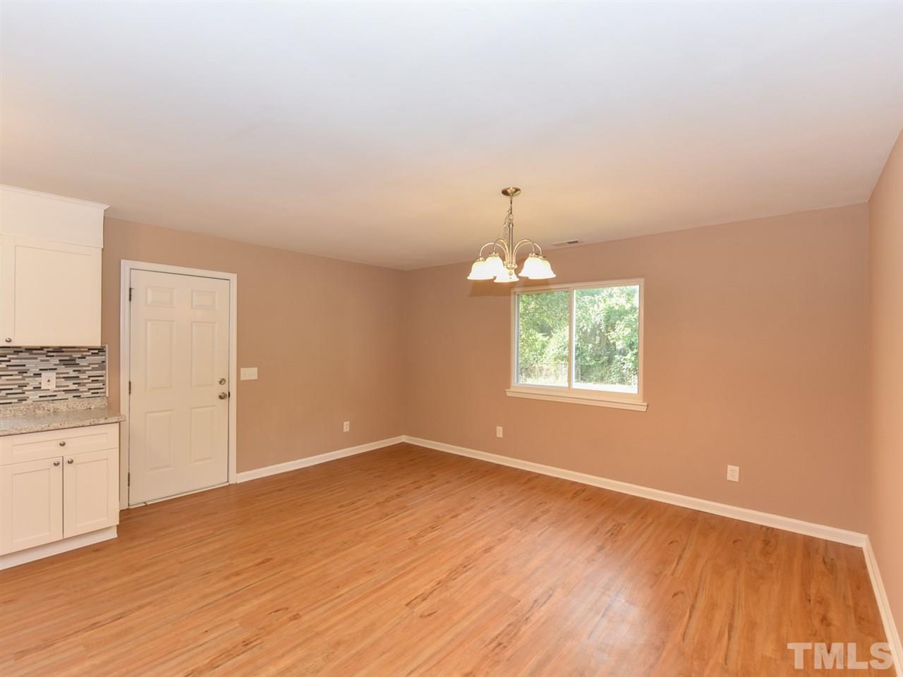 1221 Seabrook Road Raleigh, NC 27610 - Photo 5 of 16 wooden floor in an empty room with a window