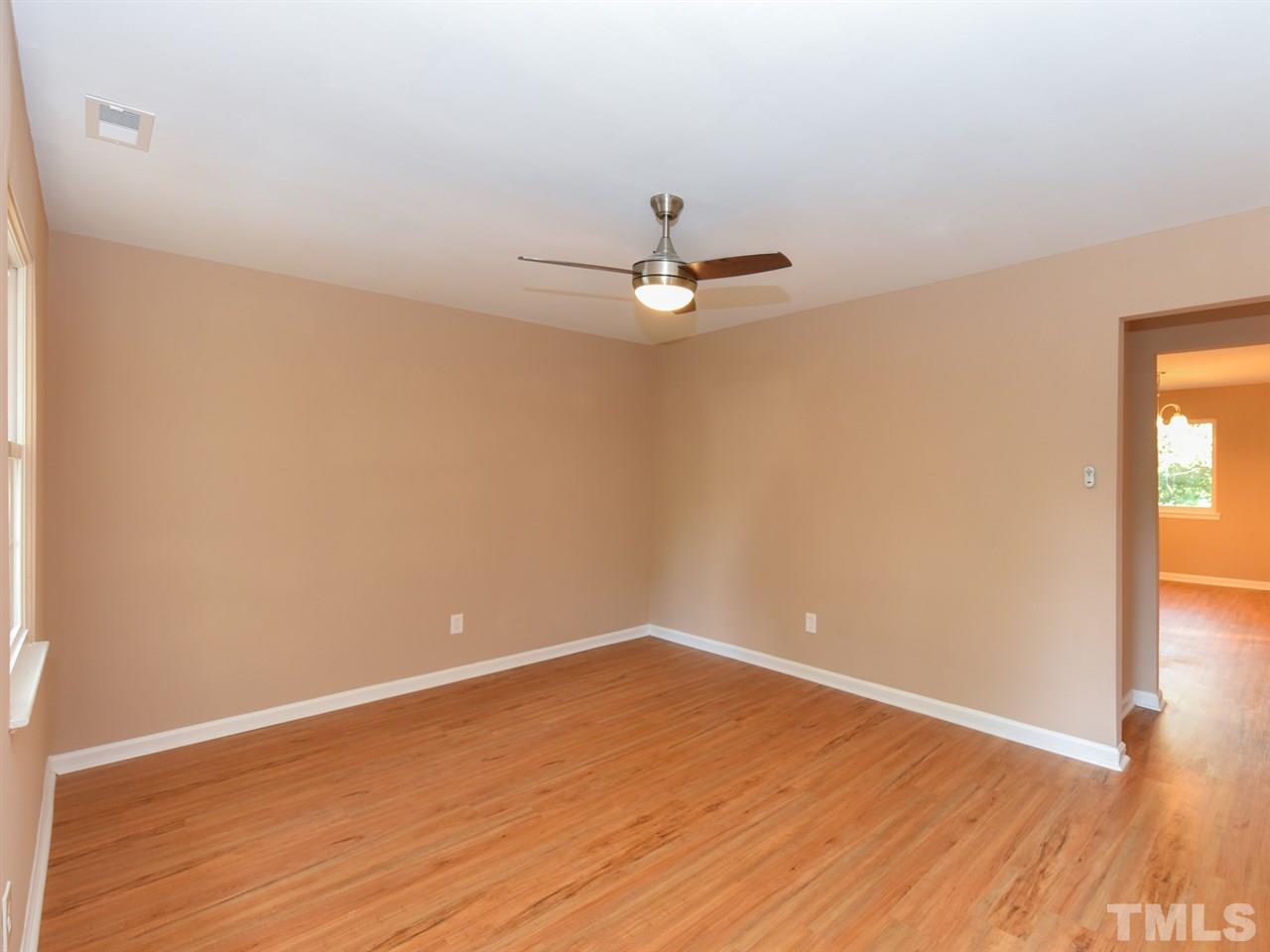 1221 Seabrook Road Raleigh, NC 27610 - Photo 7 of 16 a view of a room with wooden floor and a ceiling fan