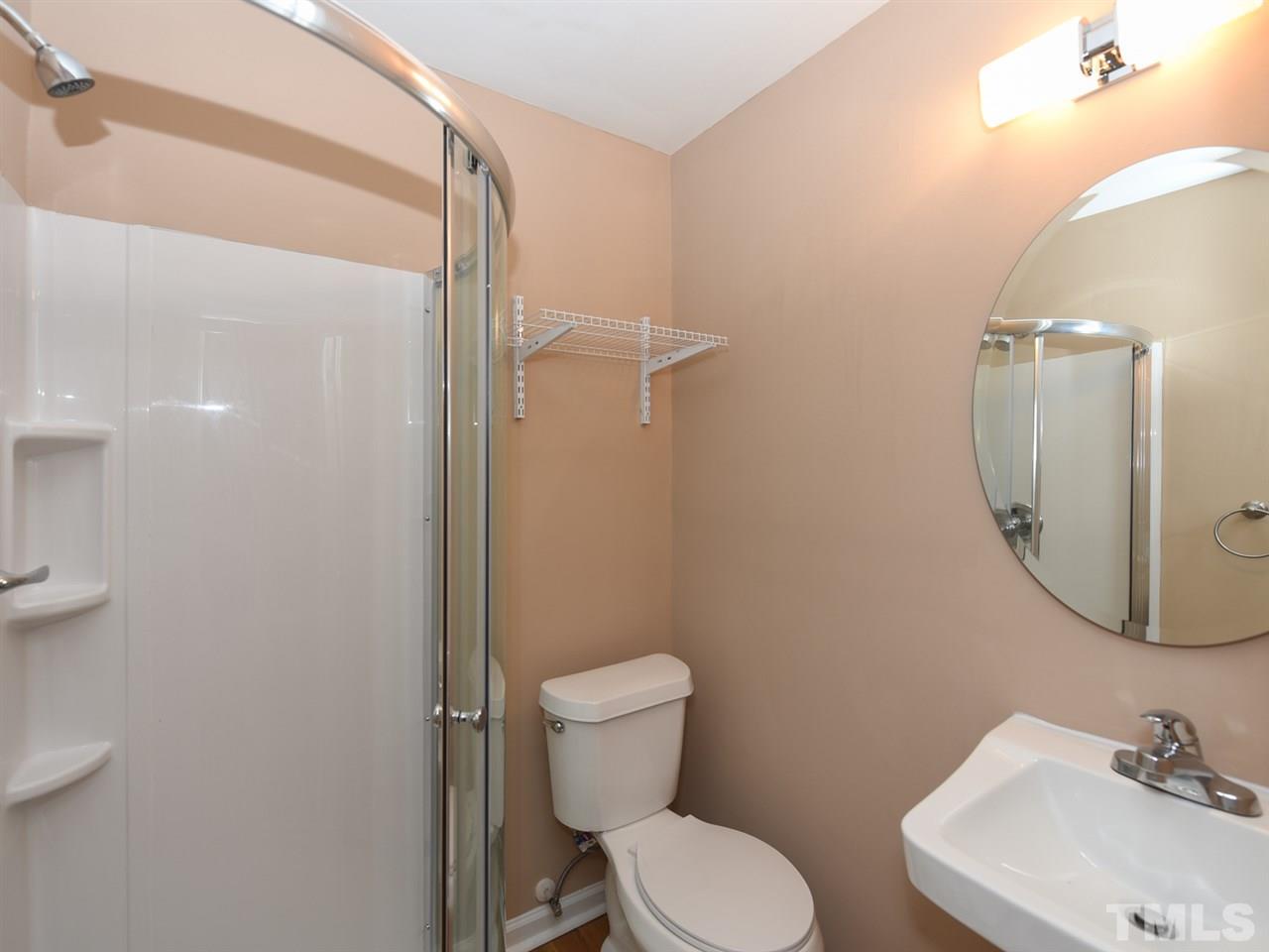 1221 Seabrook Road Raleigh, NC 27610 - Photo 9 of 16 a bathroom with a toilet a sink and mirror