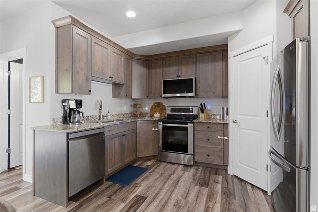 370 West Knights Lane Layton, UT 84041 - Photo 9 of 31 Kitchen featuring wood-finish flooring, light grey cabinetry, stainless steel appliances, granite-style countertops, and recessed lighting
