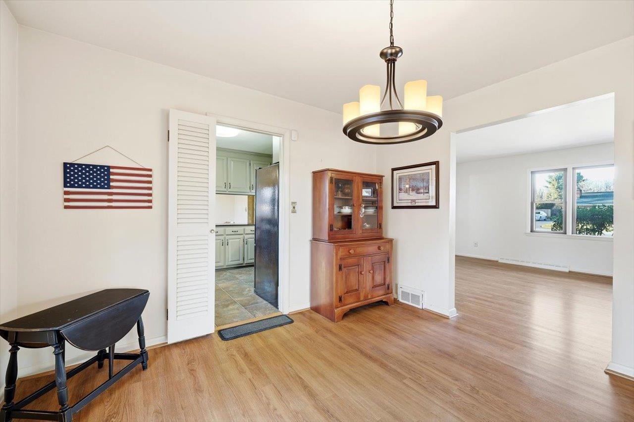 1133 Club Road Waynesboro, VA 22980 - Photo 24 of 58 a view of a livingroom with wooden floor and a chandelier