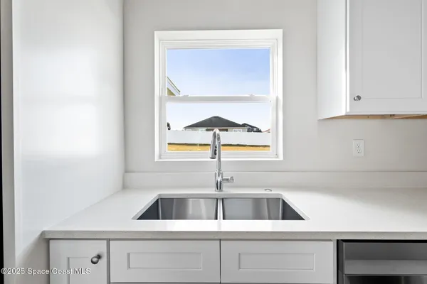 a kitchen with a sink and cabinets