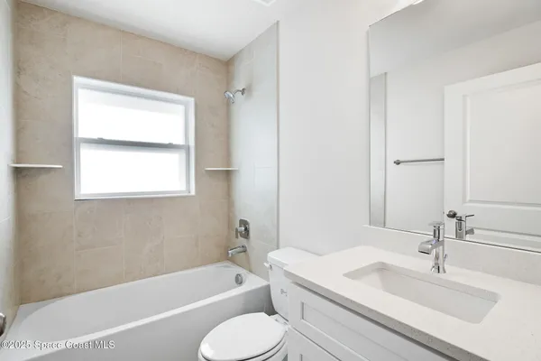 a bathroom with a granite countertop sink toilet and bathtub