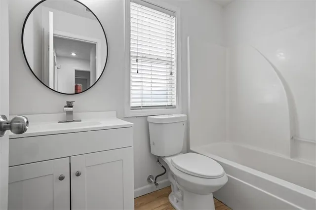 a bathroom with a toilet sink and a mirror
