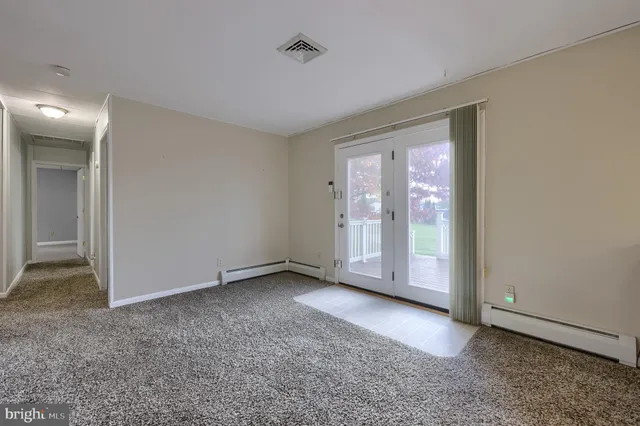 a view of a room with window and wooden floor