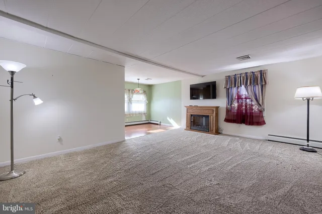 an empty room with a fireplace and window